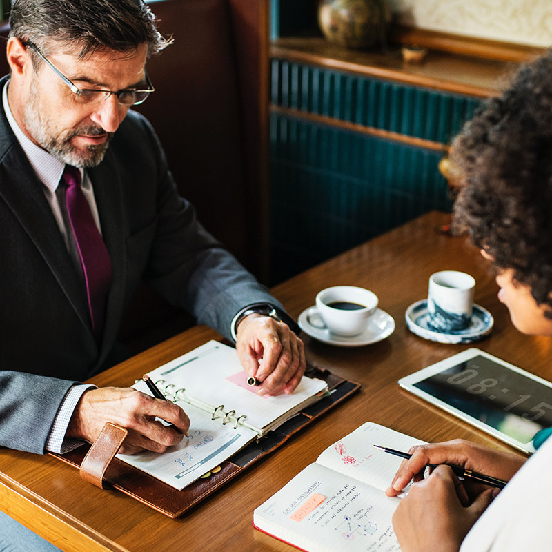 A migration consultant advising a client across a desk
